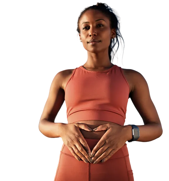 Woman forming a heart shape with her hands over her stomach